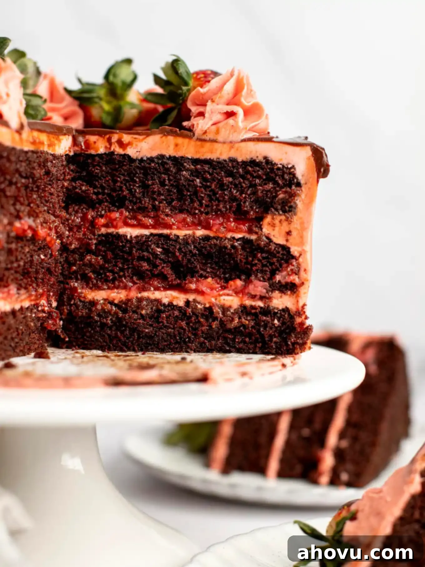 A chocolate strawberry cake that's been sliced to show all the layers. 