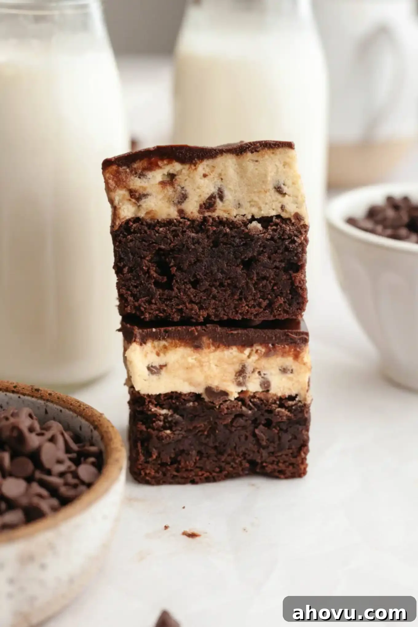 Two perfectly stacked cookie dough-topped brownies, showcasing their irresistible layers.