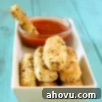 Golden Baked Mozzarella Sticks 4 Crispy Baked Mozzarella Sticks on a baking sheet