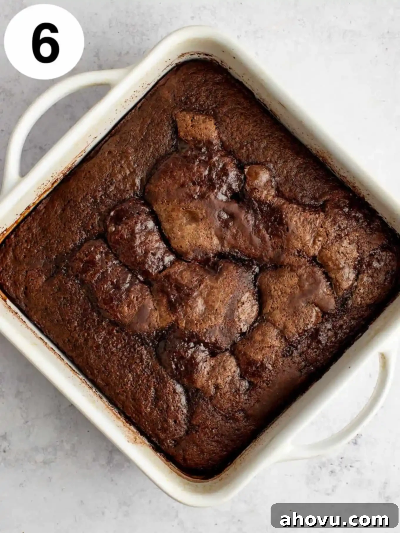 Decadent Chocolate Pudding Cake 9 An overhead view of baked chocolate pudding cake in a square baking dish.
