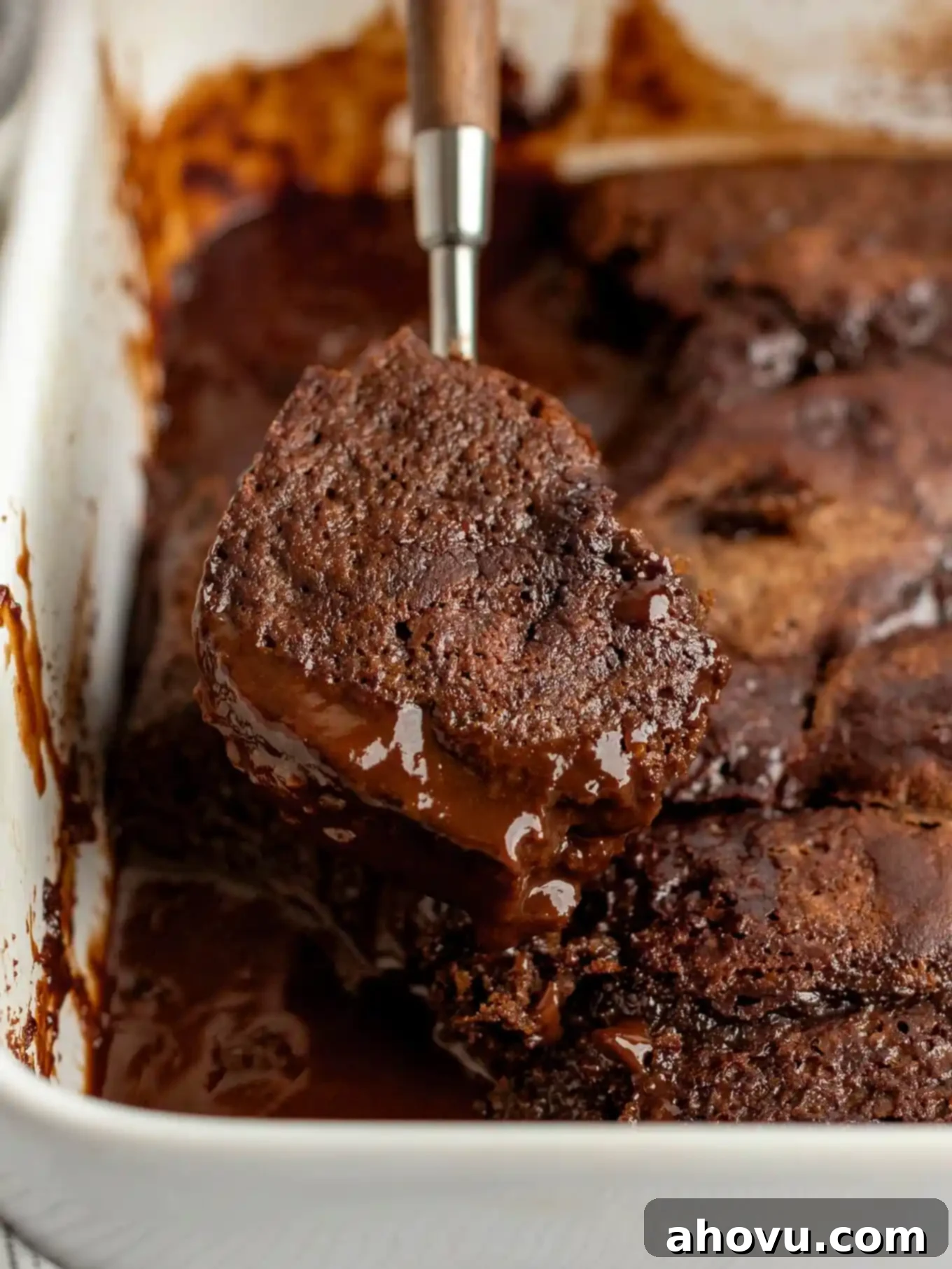 Decadent Chocolate Pudding Cake 10 A spoonful of chocolate pudding cake being lifted from a baking dish.