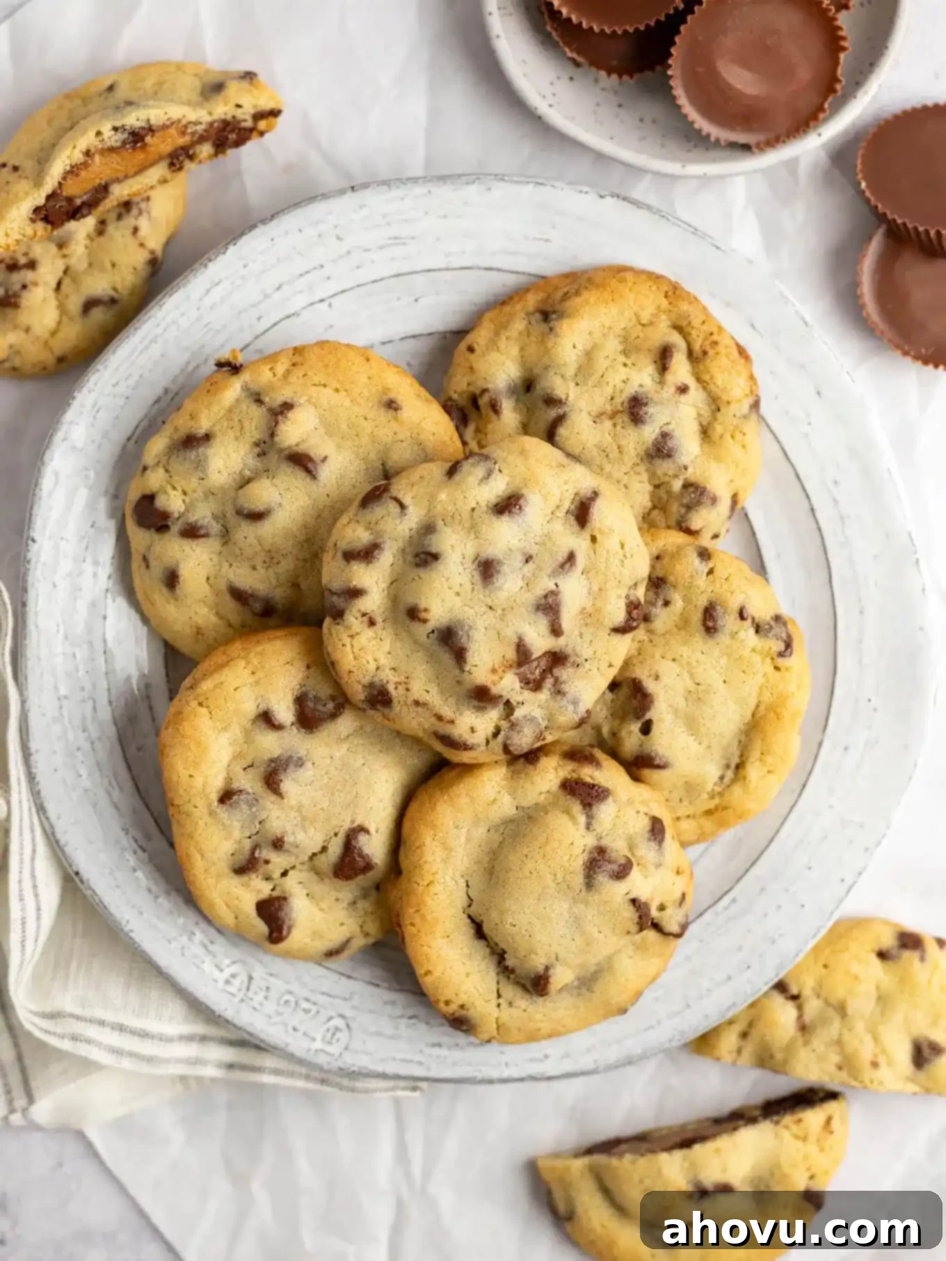 Reese's Peanut Butter Explosion Cookies 10 An overhead view of a plate of cookies stuffed with Reese's peanut butter cups.