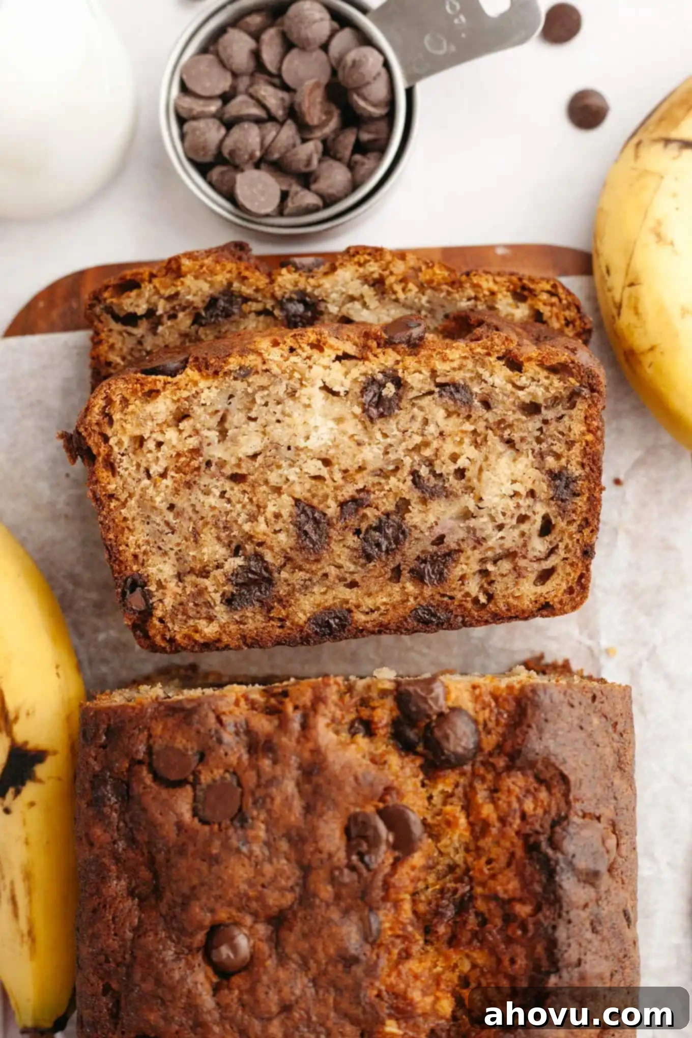 An overhead view of banana bread slices turned on their sides, showcasing moist interior and chocolate chips.