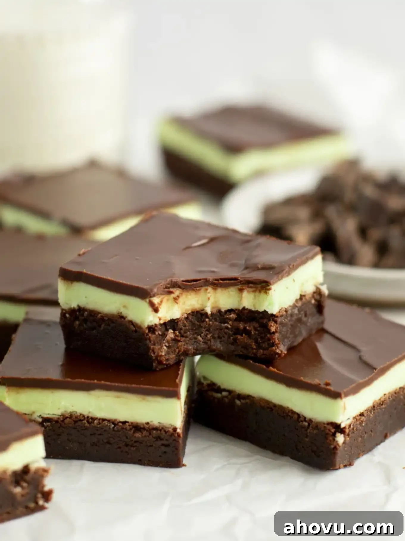 Decadent Mint Chocolate Brownies 2 A perfectly layered mint brownie with a bite missing, stacked appealingly on two more delicious brownies.