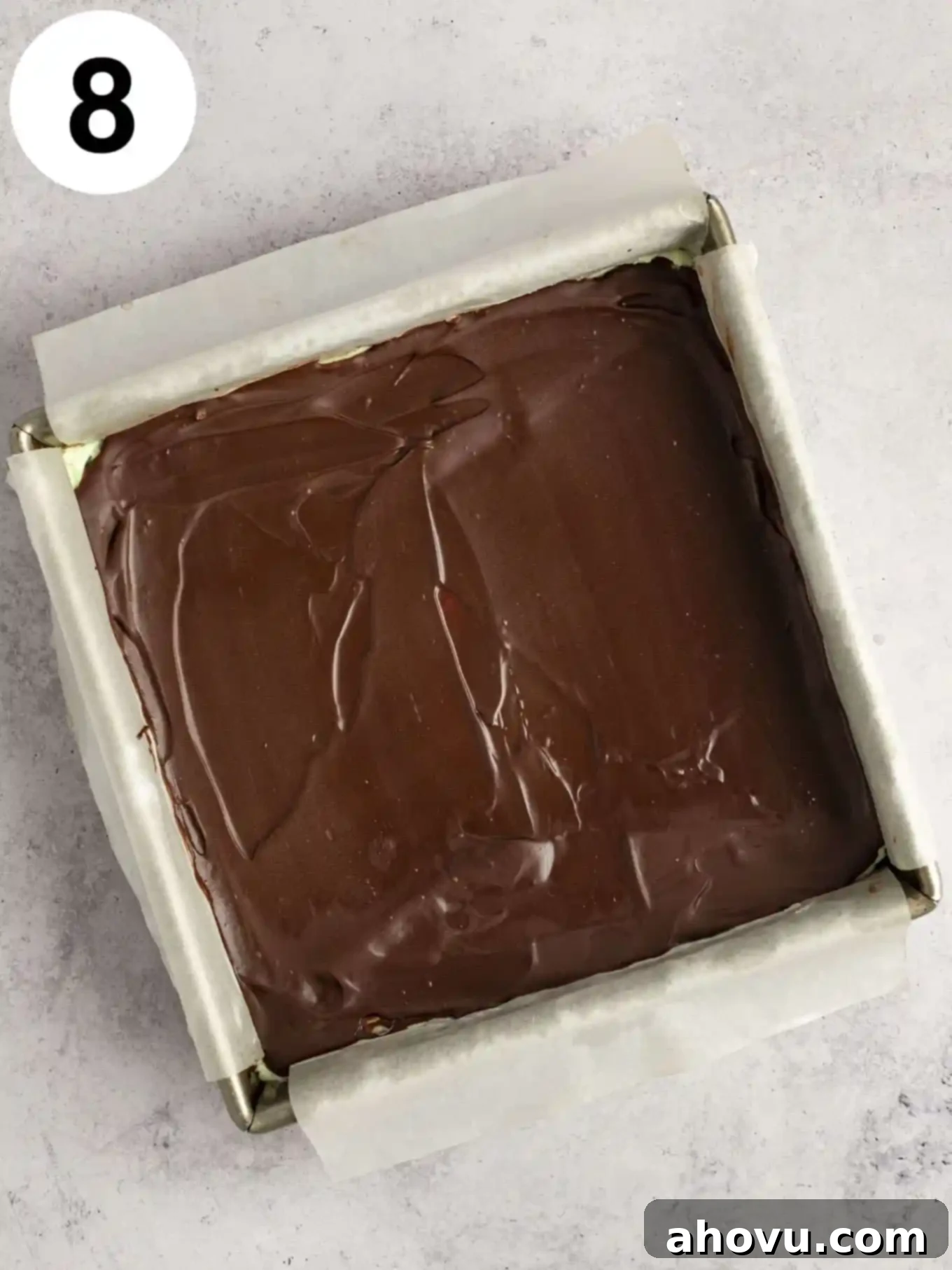 Decadent Mint Chocolate Brownies 11 An overhead view of the delightful chocolate brownies, beautifully crowned with a smooth mint frosting and a final layer of melted chocolate, all still in the pan.