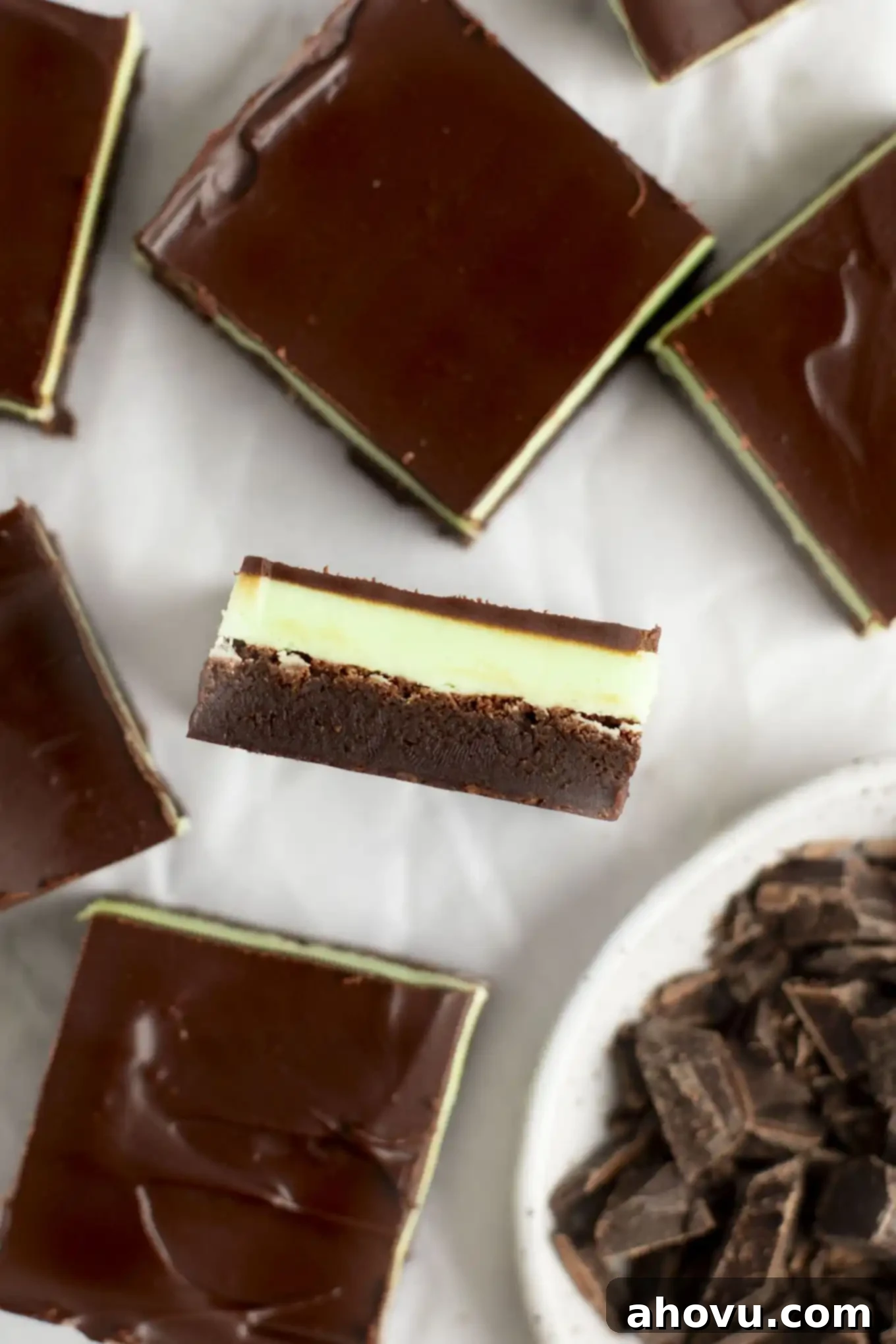 Decadent Mint Chocolate Brownies 13 An inviting overhead close-up of a mint chocolate brownie, turned on its side, revealing its distinct, beautiful layers of fudgy chocolate, creamy green mint, and a rich chocolate topping.