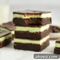 Decadent Mint Chocolate Brownies 14 A stack of mint brownies. The top brownie is missing a bite.