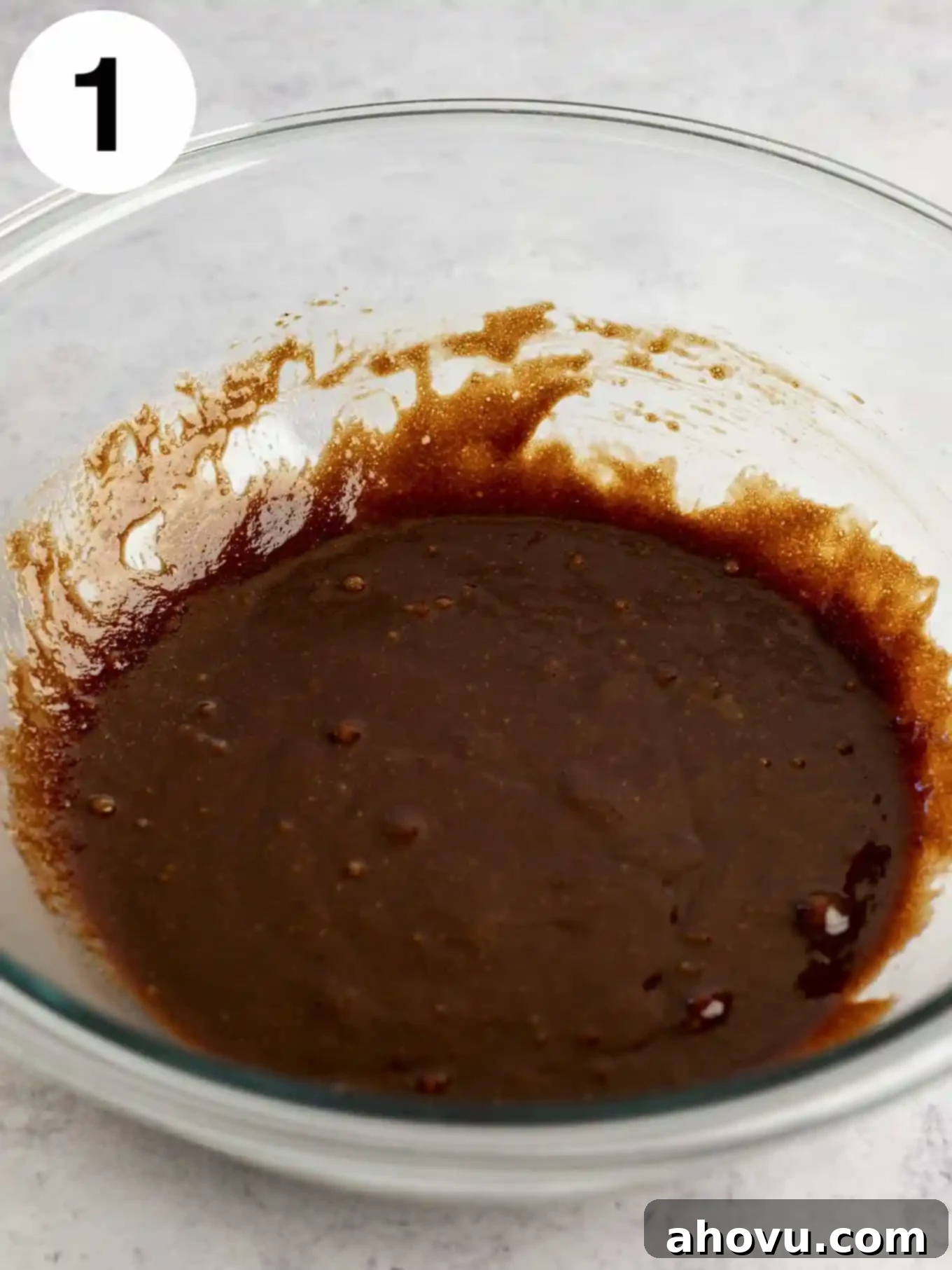 Decadent Mint Chocolate Brownies 4 A beautifully combined mixture of melted butter, rich chocolate, granulated sugar, fresh eggs, and fragrant vanilla extract in a transparent glass mixing bowl, ready for the next step.