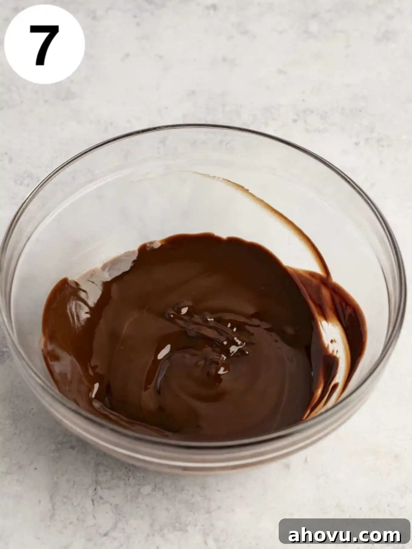 Decadent Mint Chocolate Brownies 10 A glistening, perfectly melted chocolate mixture in a transparent glass mixing bowl, ready to be poured.