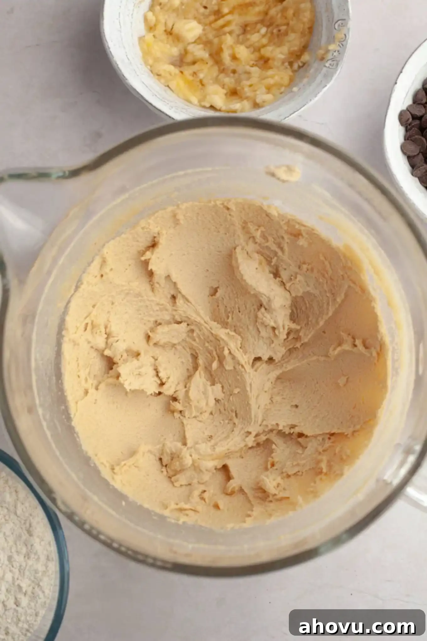 Irresistible Banana Chocolate Chip Cookies 5 Butter and sugar creamed together in a glass mixing bowl, looking light and fluffy.