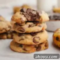 A stack of banana chocolate chip cookies. The top cookie has a bite taken out of it.