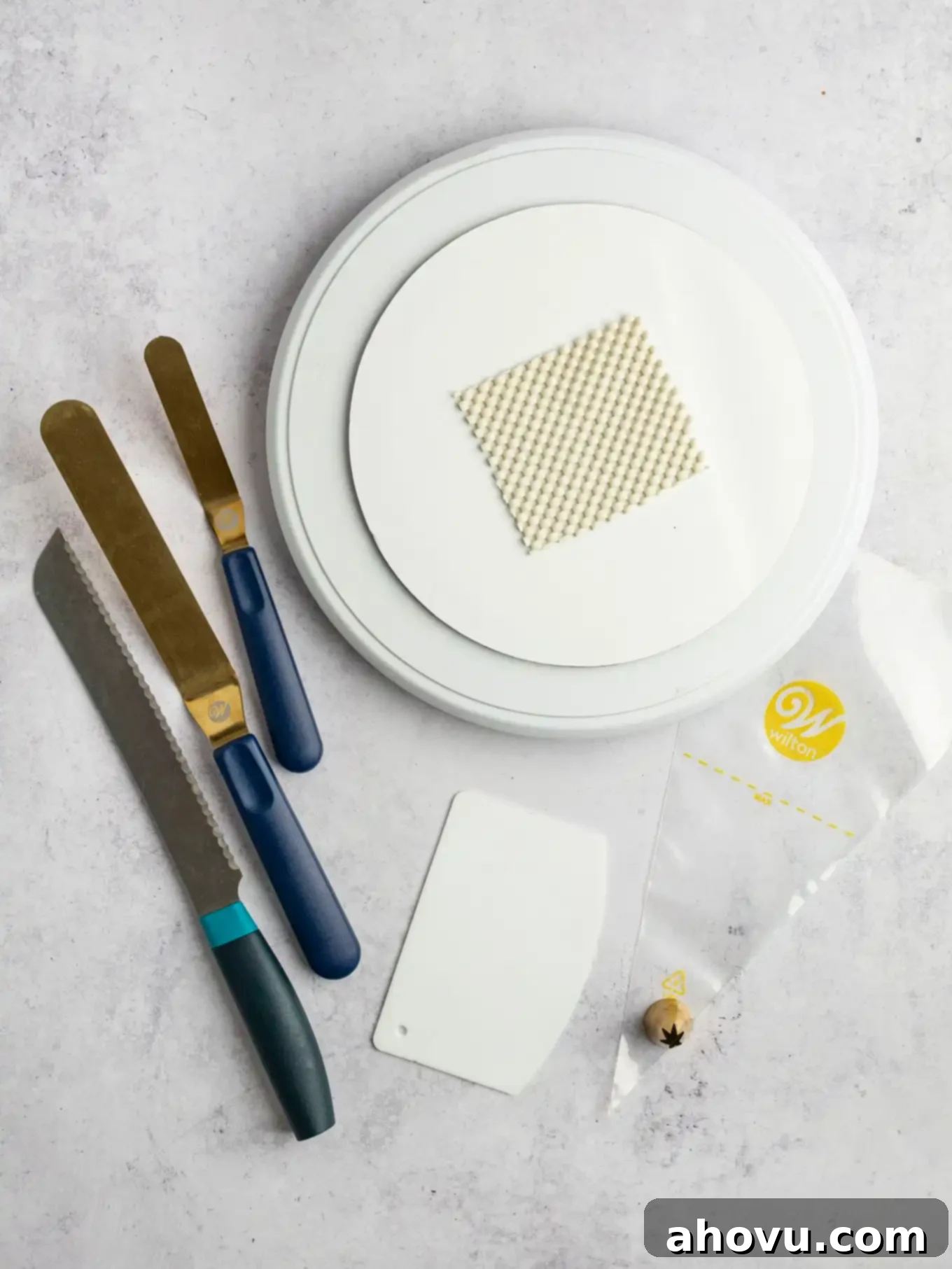 An overhead view of basic cake decorating tools. 