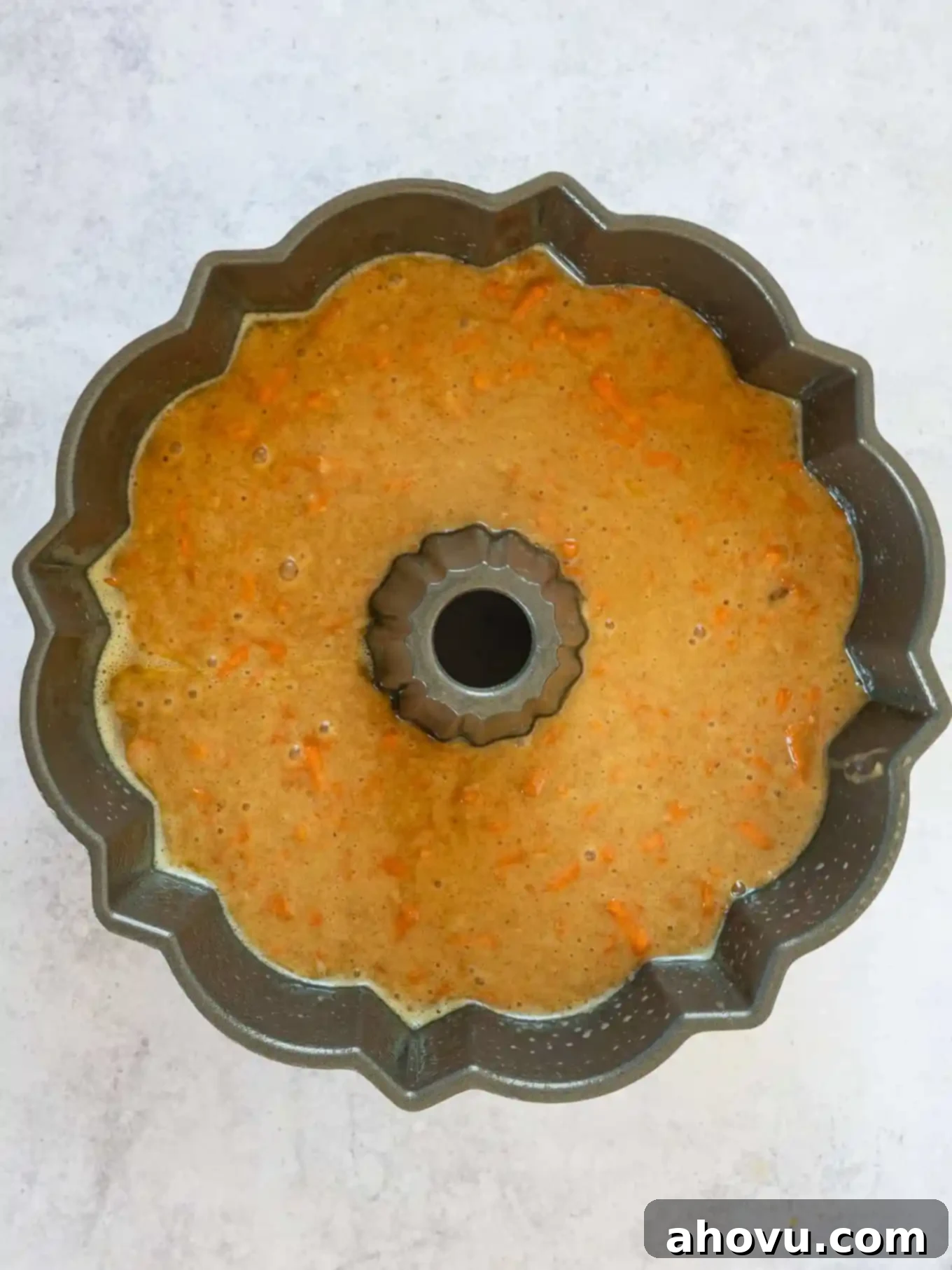 An overhead view of carrot cake batter in a bundt pan. 