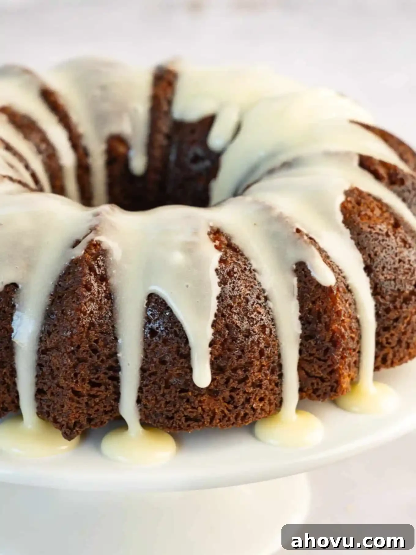 A bundt carrot cake drizzled with cream cheese icing. 