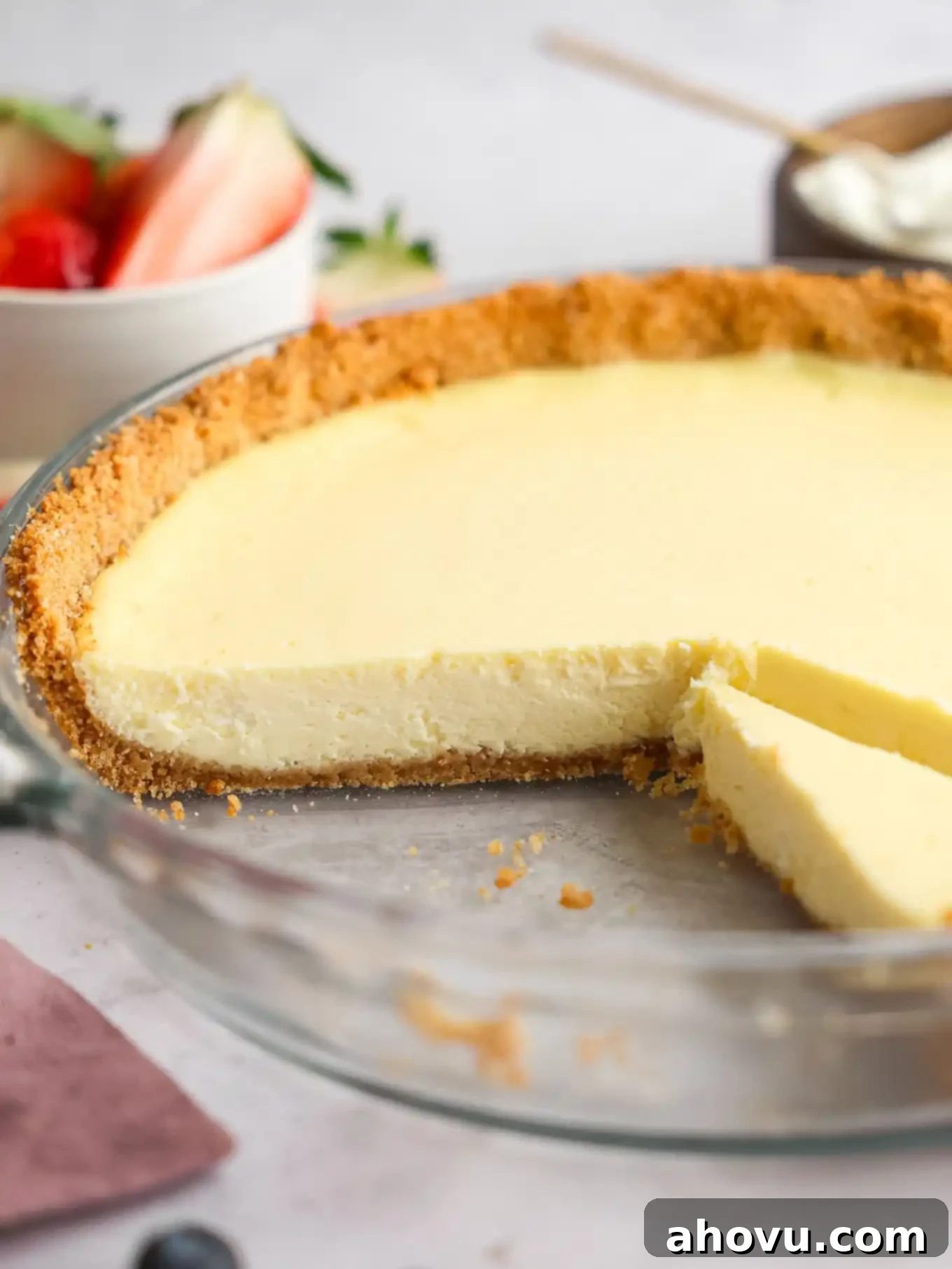 A cheesecake pie that's been sliced to show the texture of the filling. 