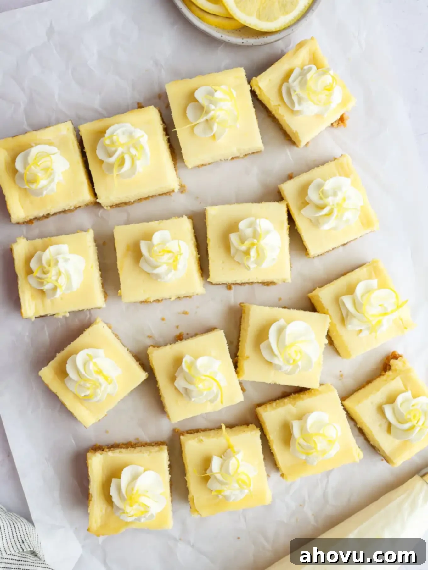 Overhead view of perfectly sliced lemon cheesecake bars, showcasing their creamy filling and golden crust.
