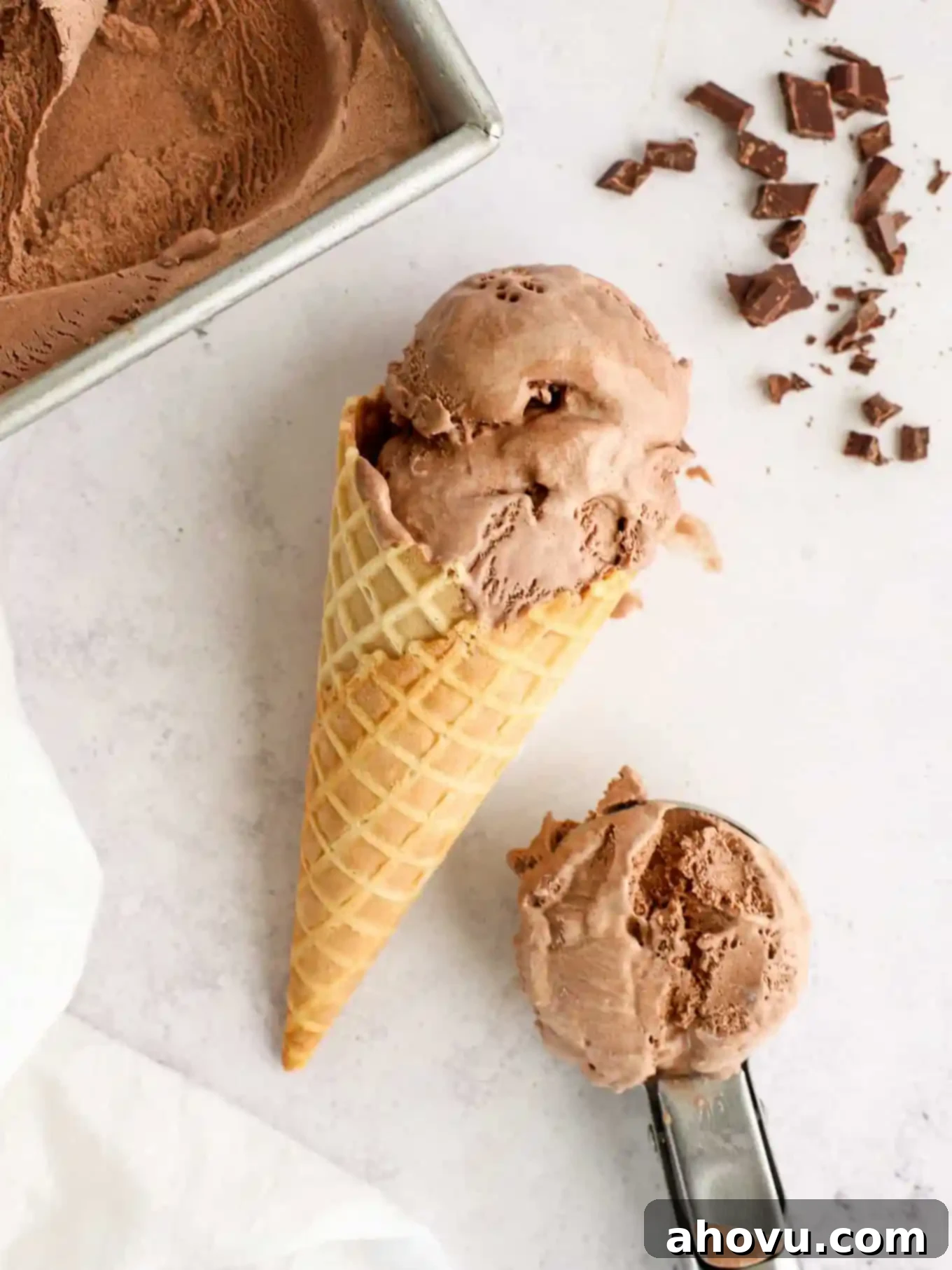 Decadent Chocolate Delight 2 A chocolate ice cream cone on its side, with a scoop of ice cream on the side, inviting to be enjoyed.