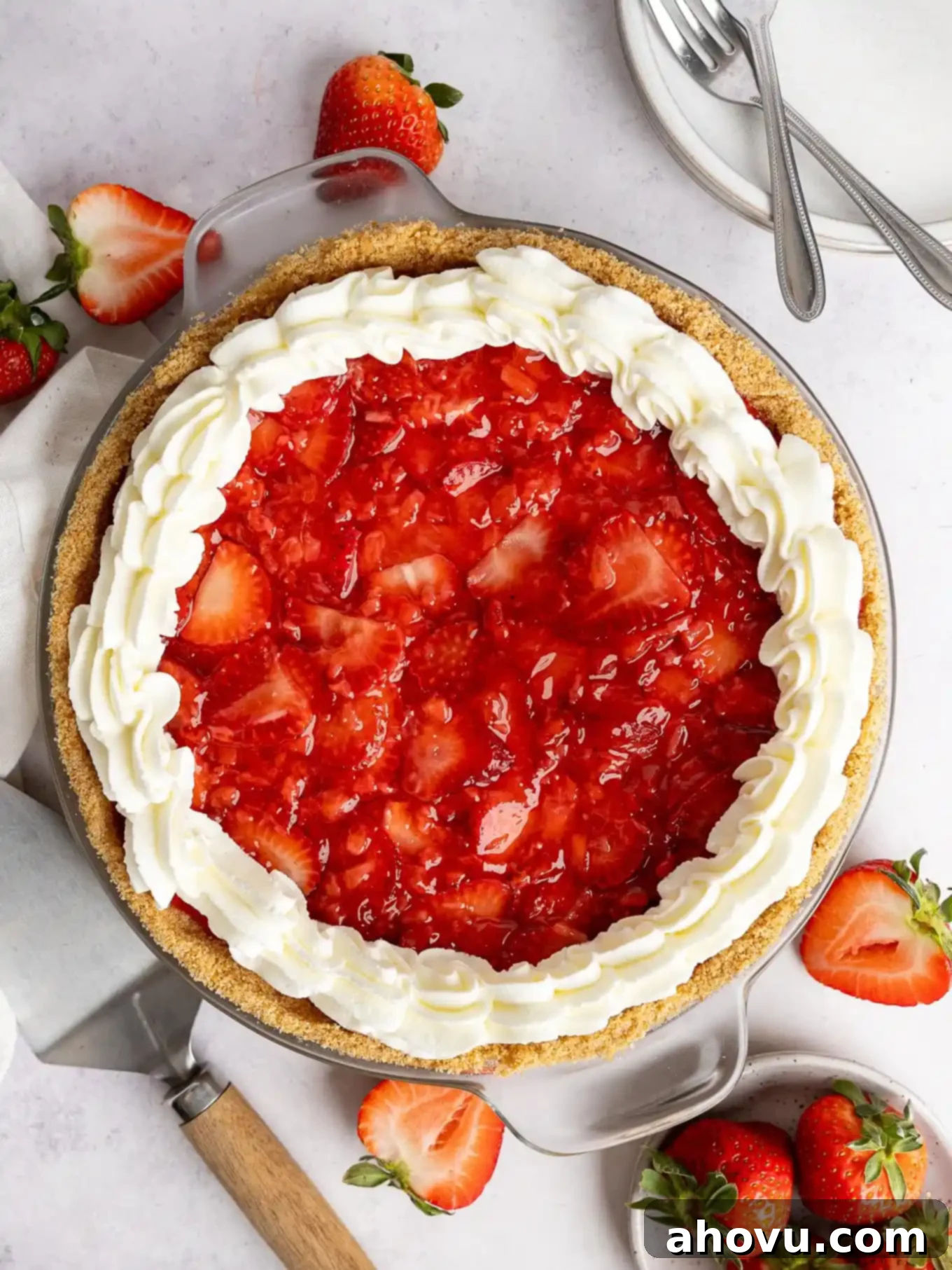 An overhead view of a strawberry cream cheese pie, showcasing its beautiful layers of crust, creamy filling, and fresh berry topping.
