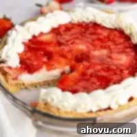 A strawberry cream cheese pie with a slice missing, showing the layers.
