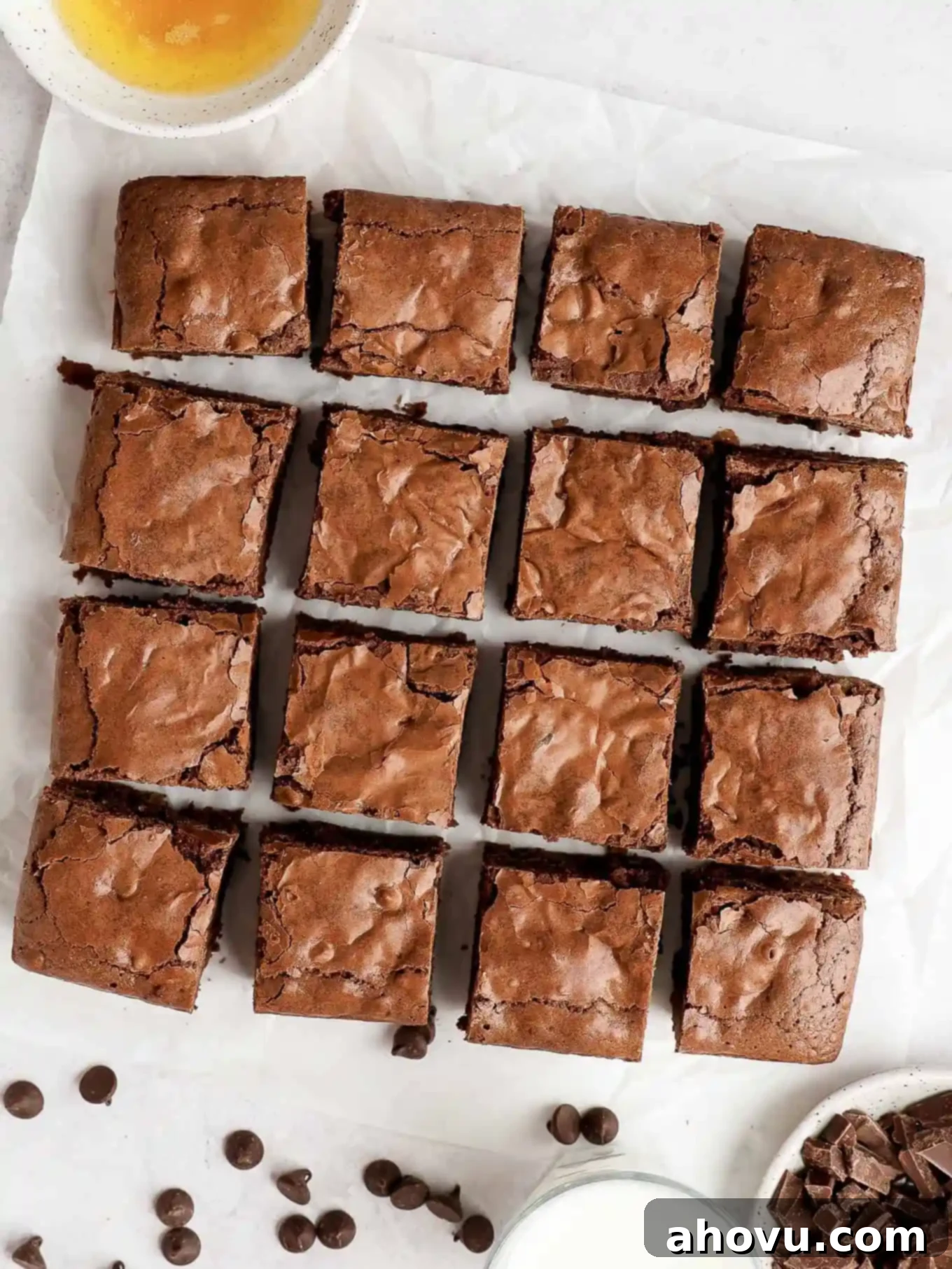 Golden Brown Butter Brownies 2 An overhead view of sliced brown butter brownies on parchment paper.
