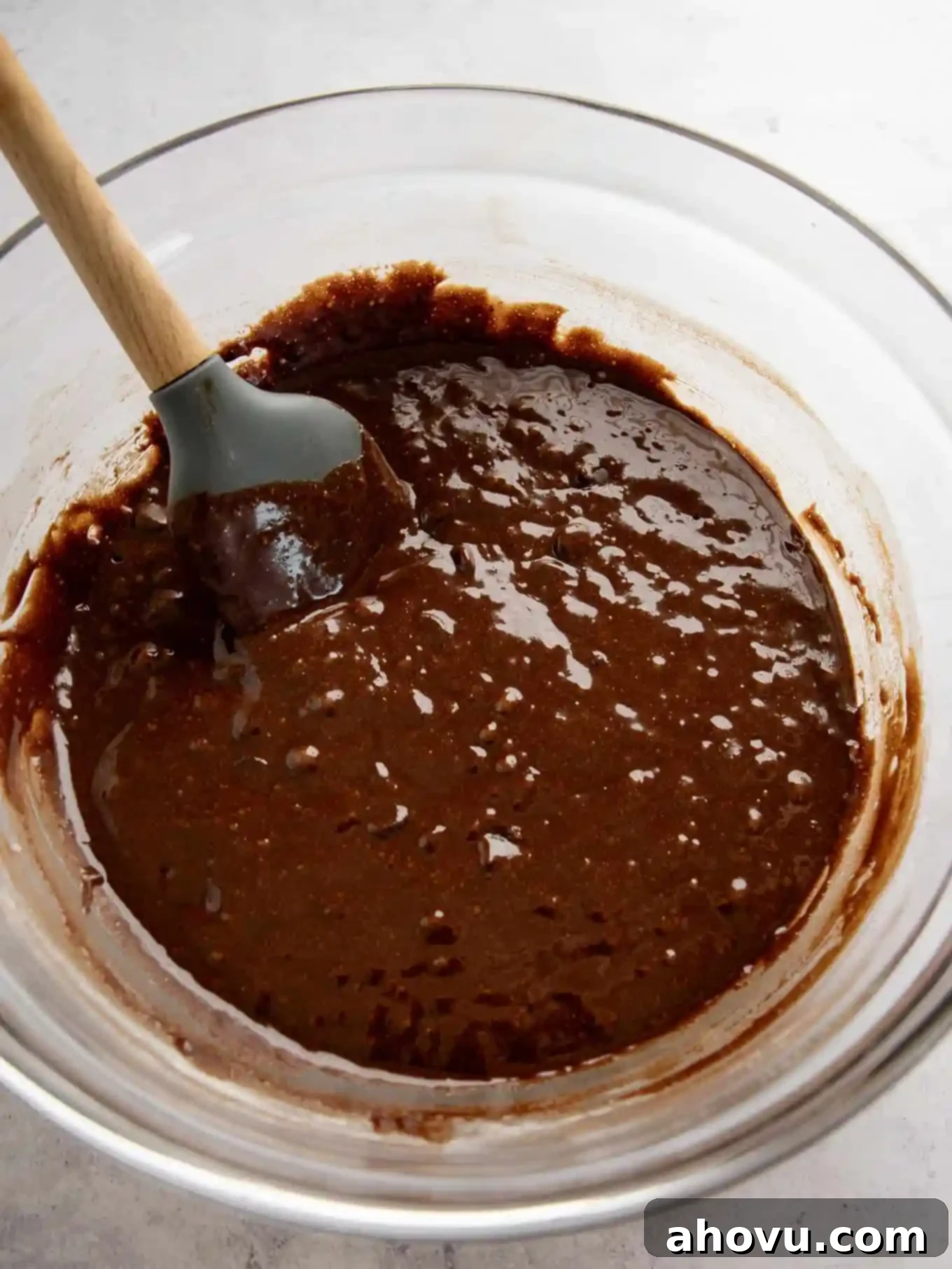 Golden Brown Butter Brownies 5 An overhead view of brown butter brownie batter in a bowl with a spatula.