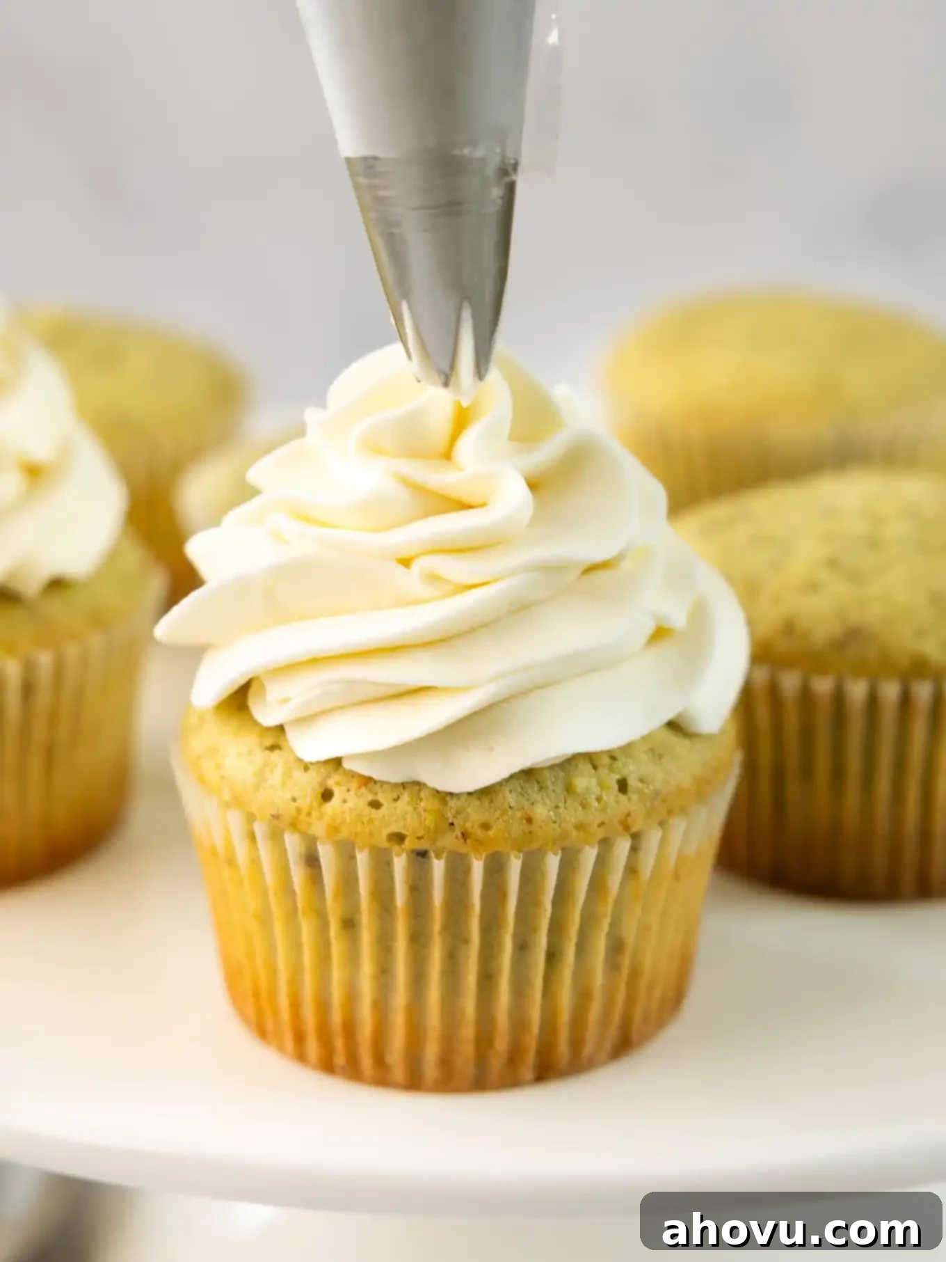 A perfectly piped pistachio cupcake with mascarpone frosting, ready to be enjoyed.