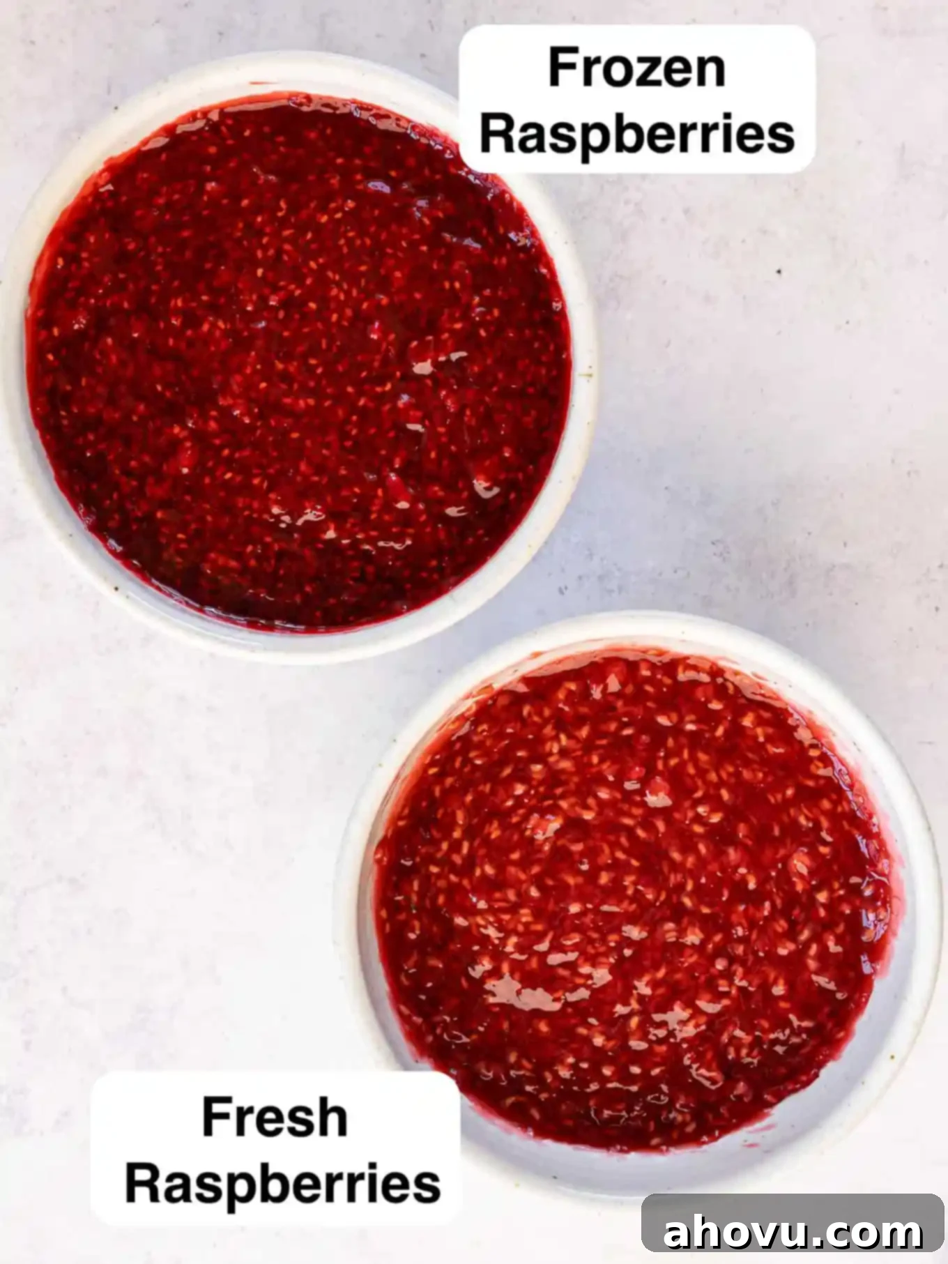 A side-by-side comparison of two bowls of raspberry filling, one made with fresh berries and the other with frozen, highlighting subtle color and texture variations.
