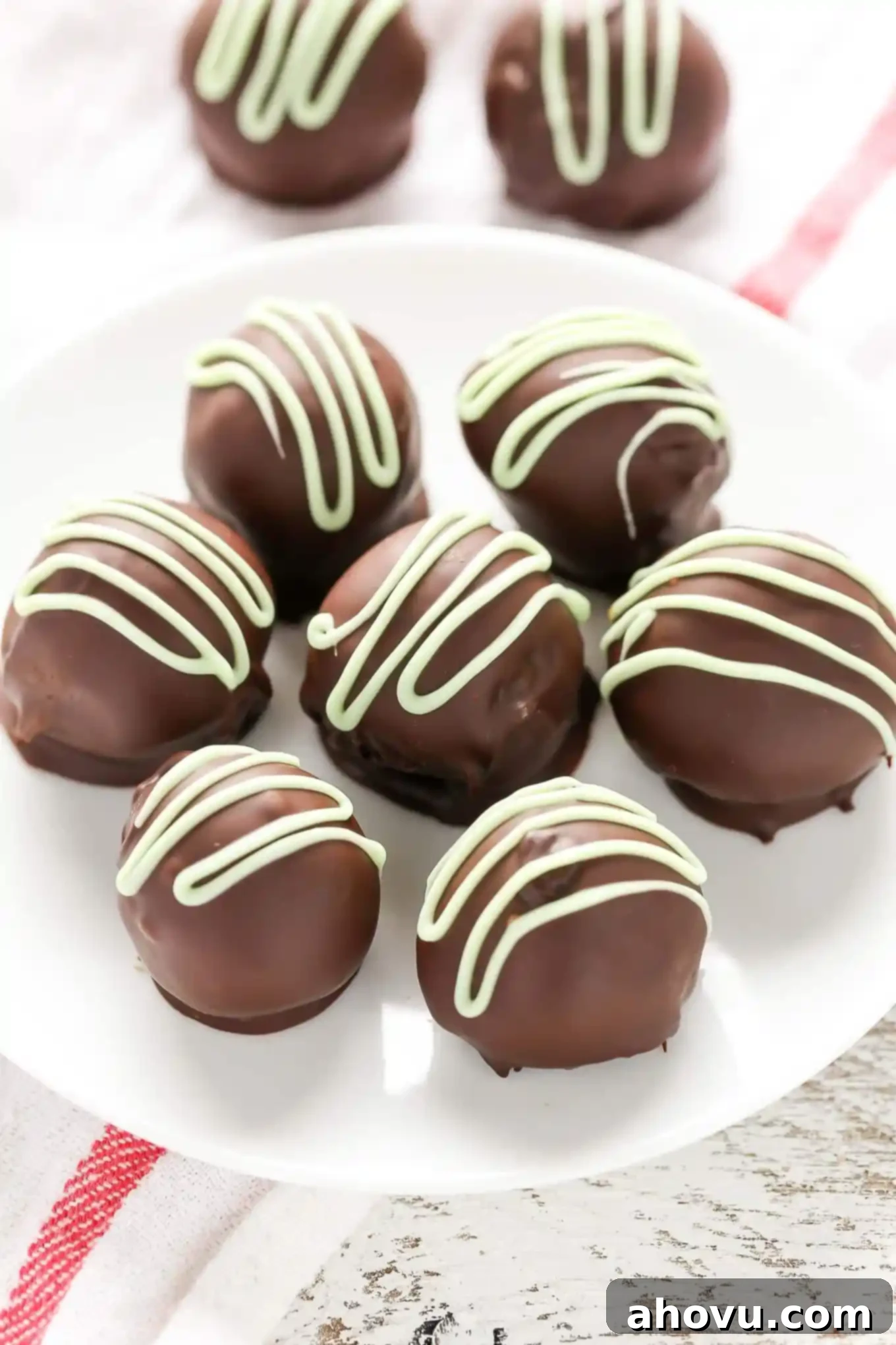 Lush, homemade mint chocolate truffles arranged beautifully, highlighting their rich texture and perfect spherical shape.