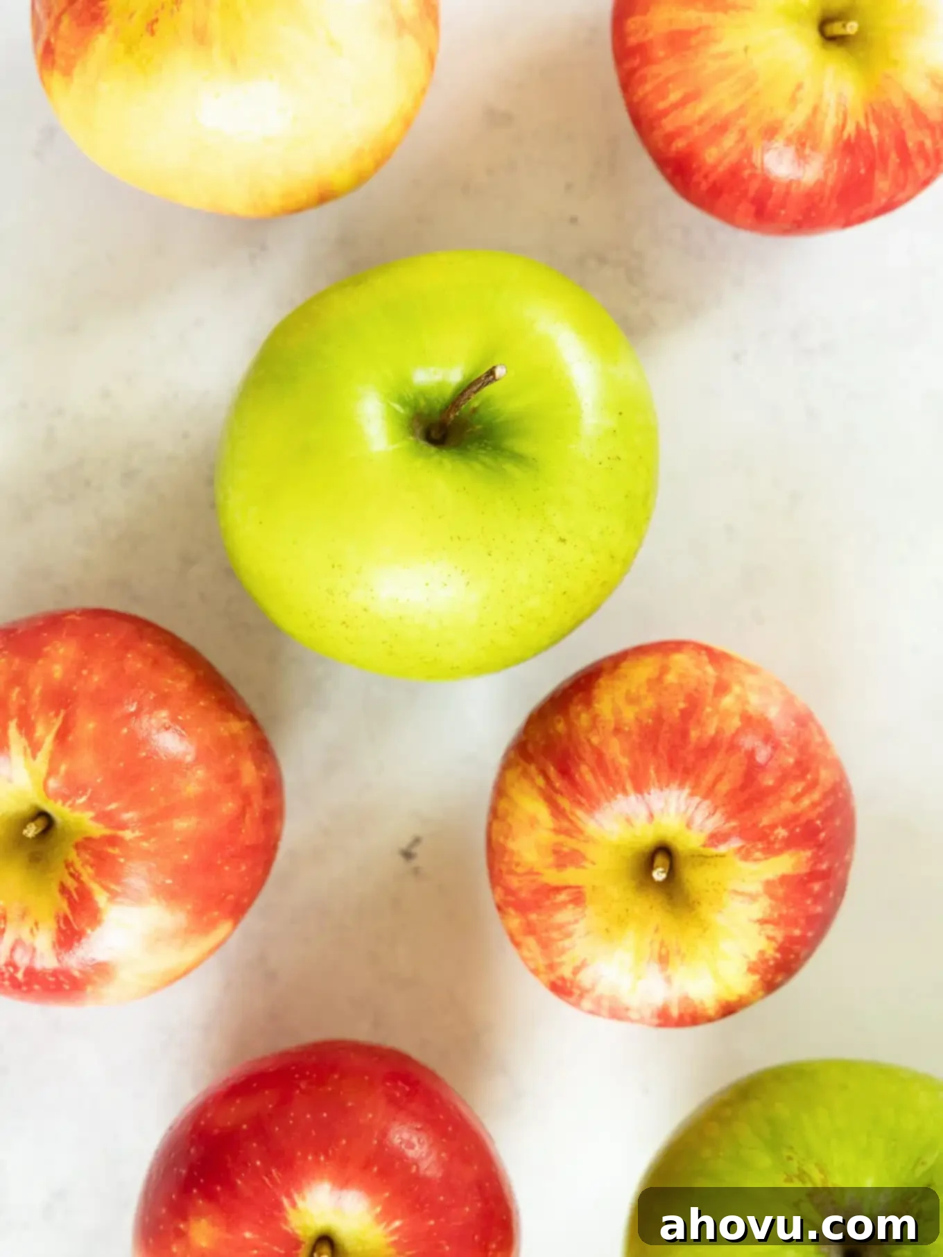 Granny Smith and Honeycrisp apples on a counter. 