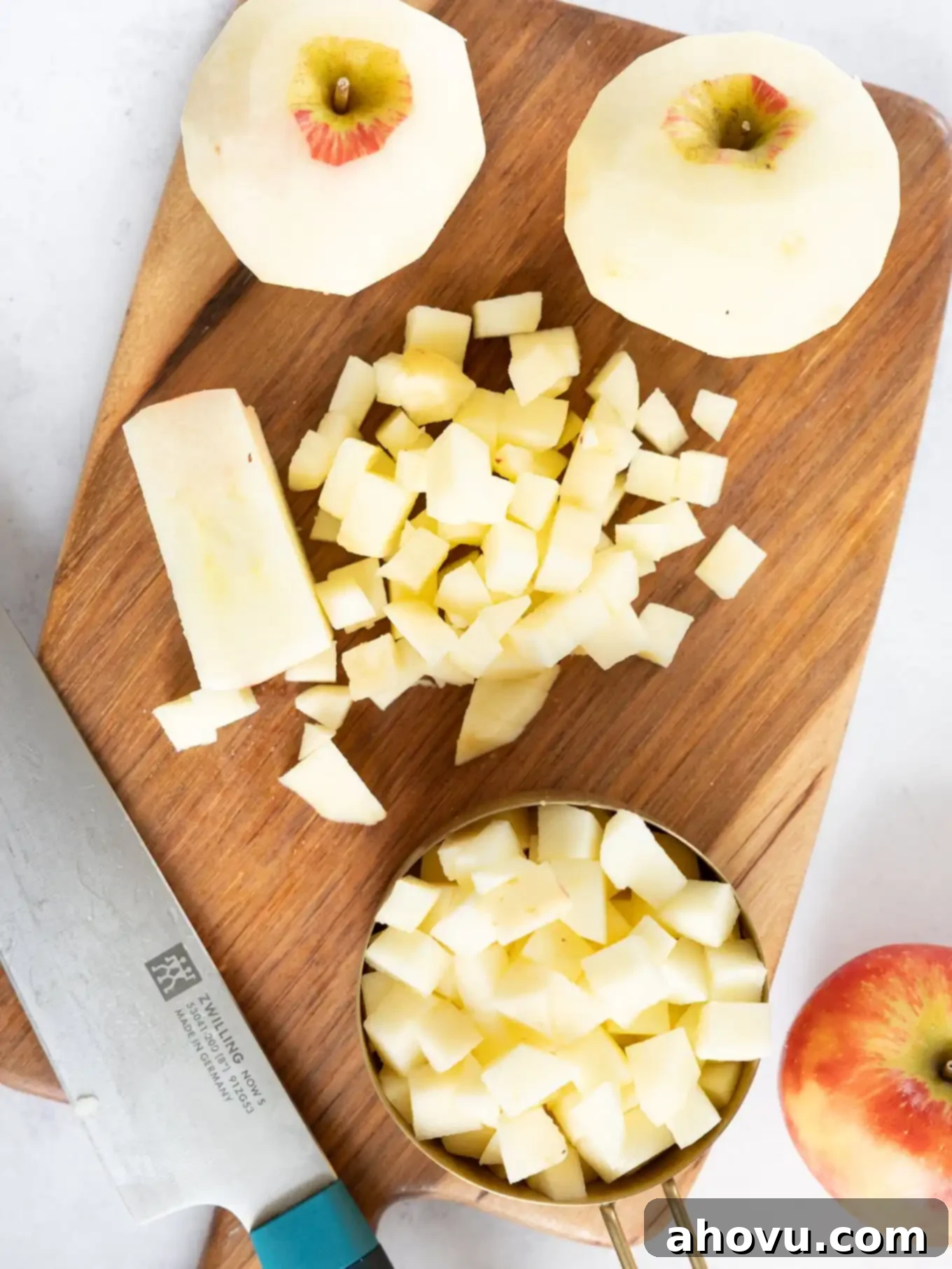 Peeled and chopped apples on a cutting board. 