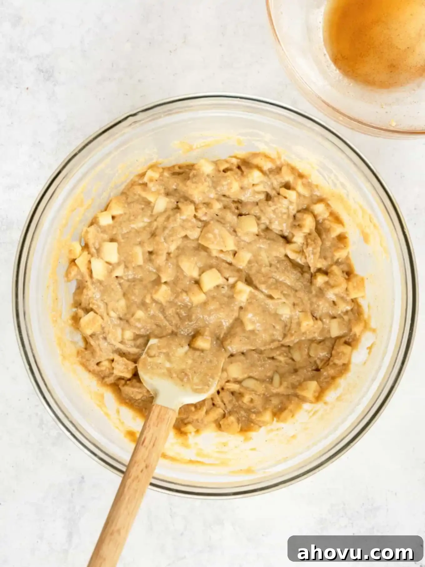 Apple fritter cake batter in a mixing bowl. 
