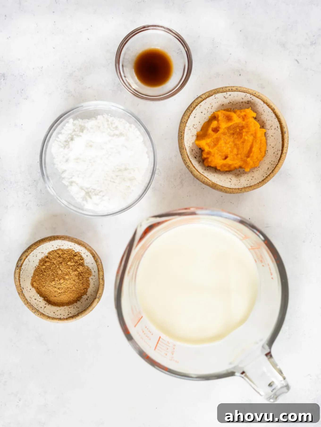 The simple, essential ingredients needed to create this delicious pumpkin spice whipped cream recipe, laid out on a kitchen surface.