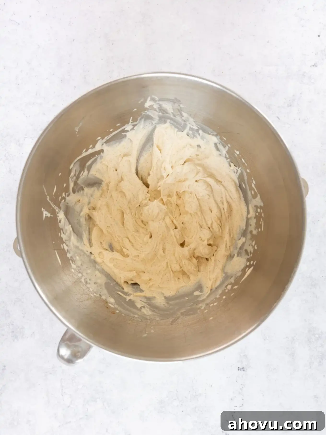 Beautifully whipped pumpkin spice whipped cream in a mixing bowl, showcasing its fluffy, stable texture after whipping.