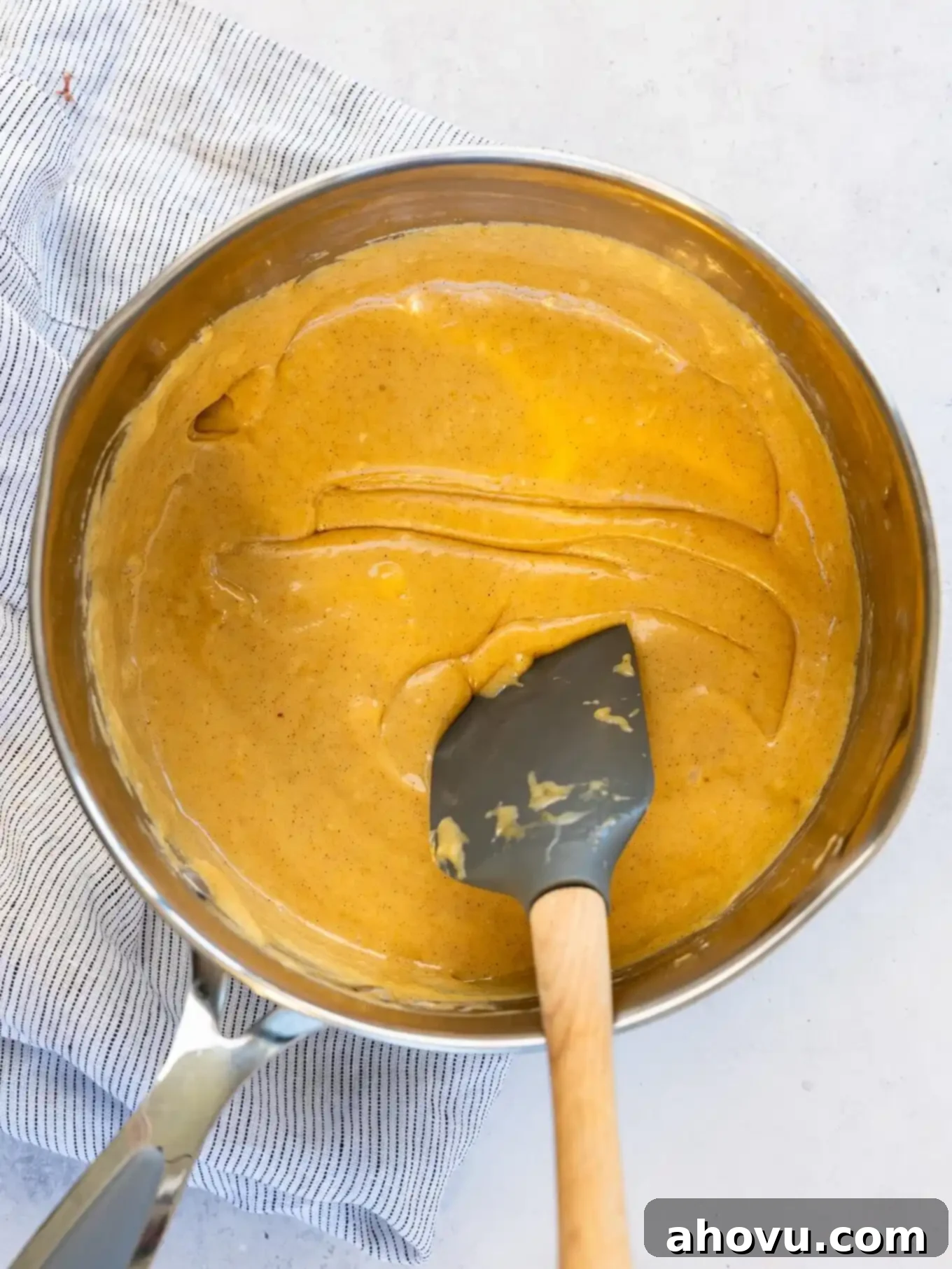 Pumpkin Spice Fudge 7 An overhead view of the smooth, golden-orange pumpkin fudge mixture, fully melted and blended, inside a saucepan.
