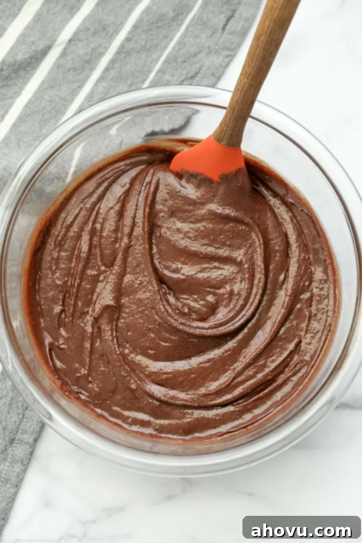 Heavenly Homemade Brownies 3 A clear mixing bowl filled with rich, glossy homemade brownie batter, ready to be spread into a pan.
