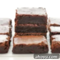 Heavenly Homemade Brownies 6 A stack of perfectly sliced homemade fudgy brownies on parchment paper, ready to enjoy.