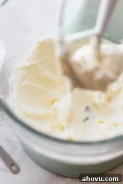 A glass mixing bowl showing frosting being mixed up.