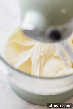 A glass mixing bowl with frosting that has finished mixing showing its smooth texture.
