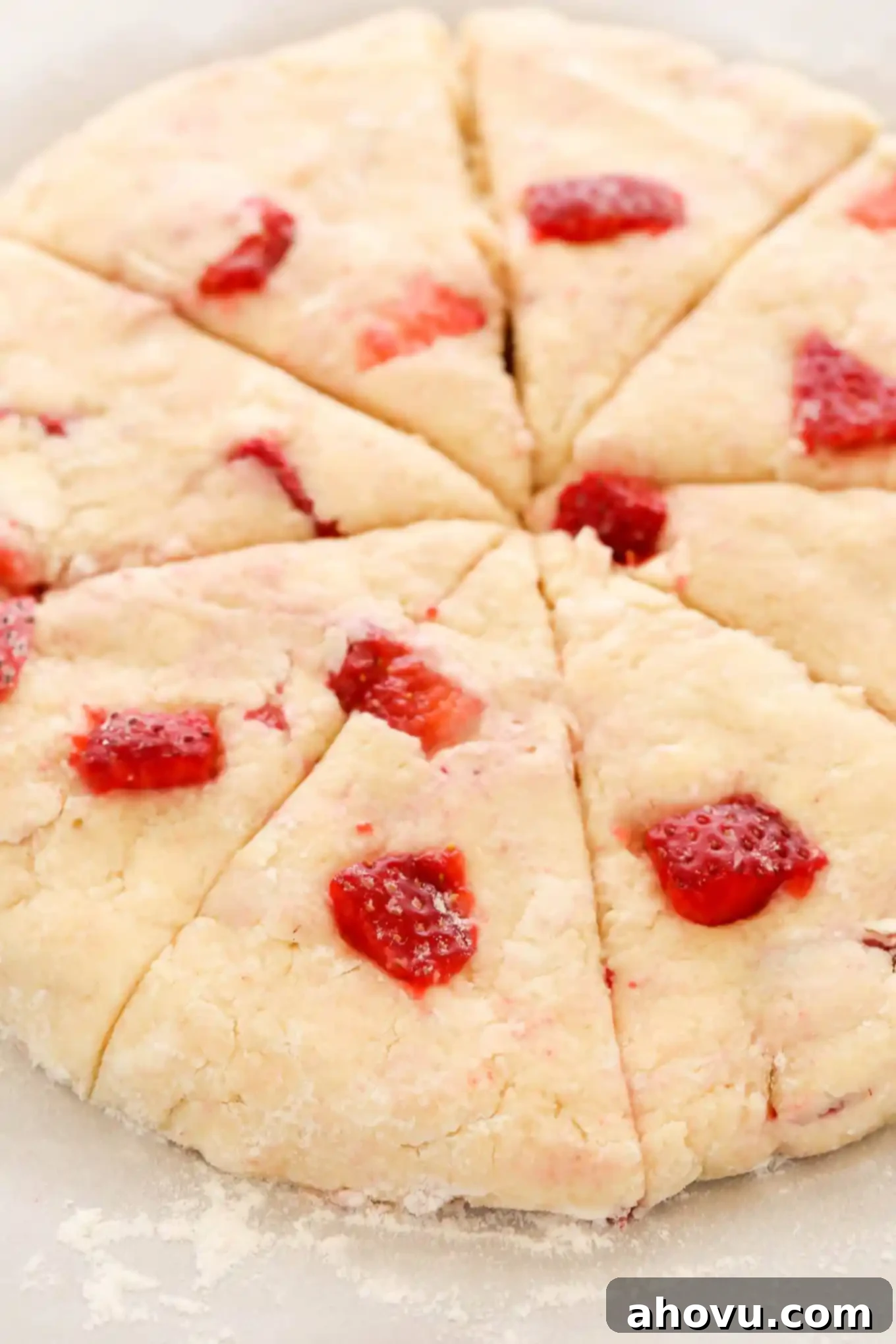 Homemade Strawberry Cream Scones 5 Eight perfectly shaped and cut strawberry scones arranged on a baking sheet, ready for the oven to achieve a golden-brown finish.