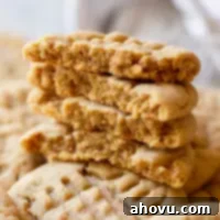 A stack of peanut butter cookies on top of other cookies.