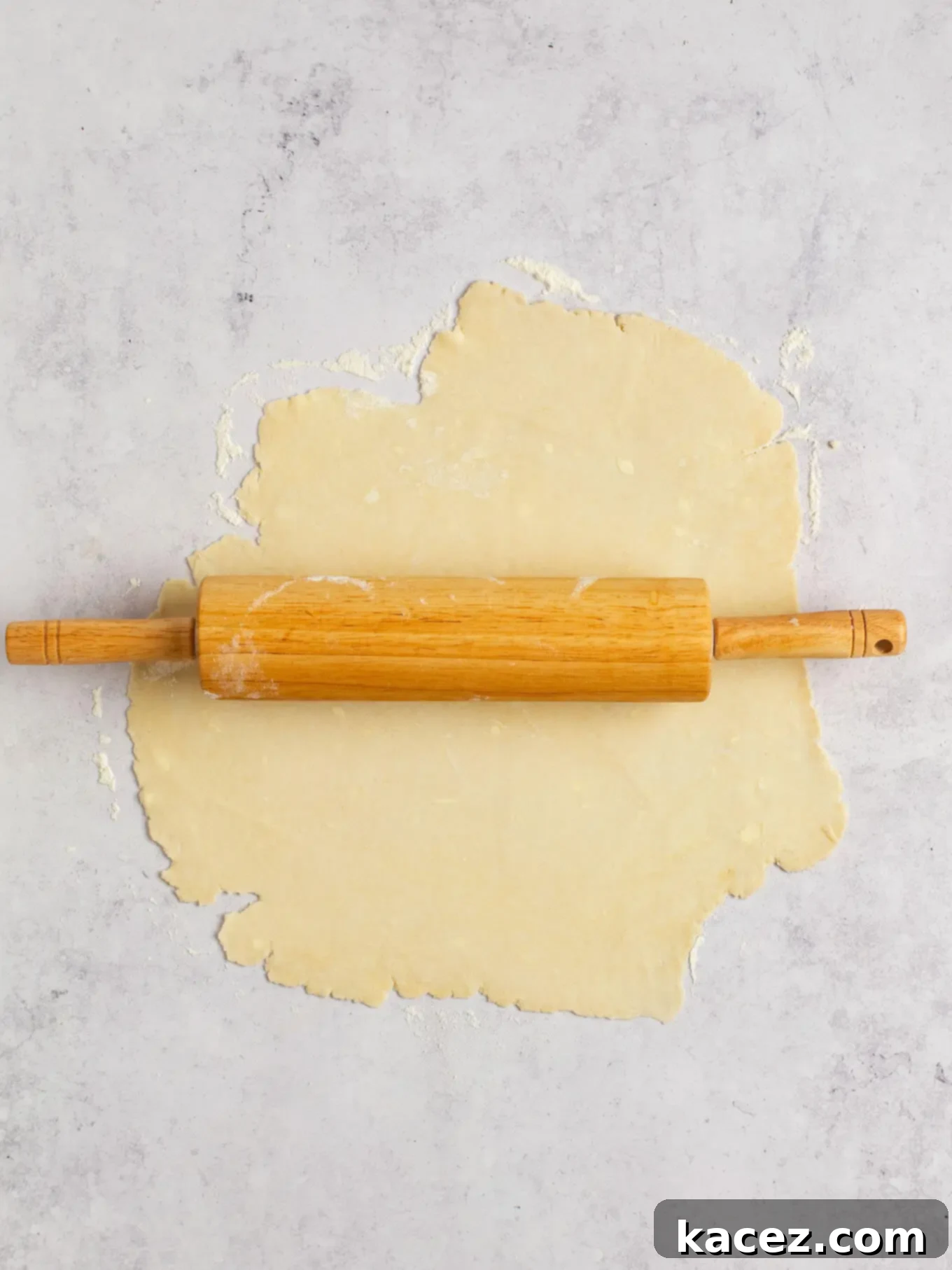 Spiced Pumpkin Pastries 4 Pie dough being rolled out on a floured surface, ready for cutting.