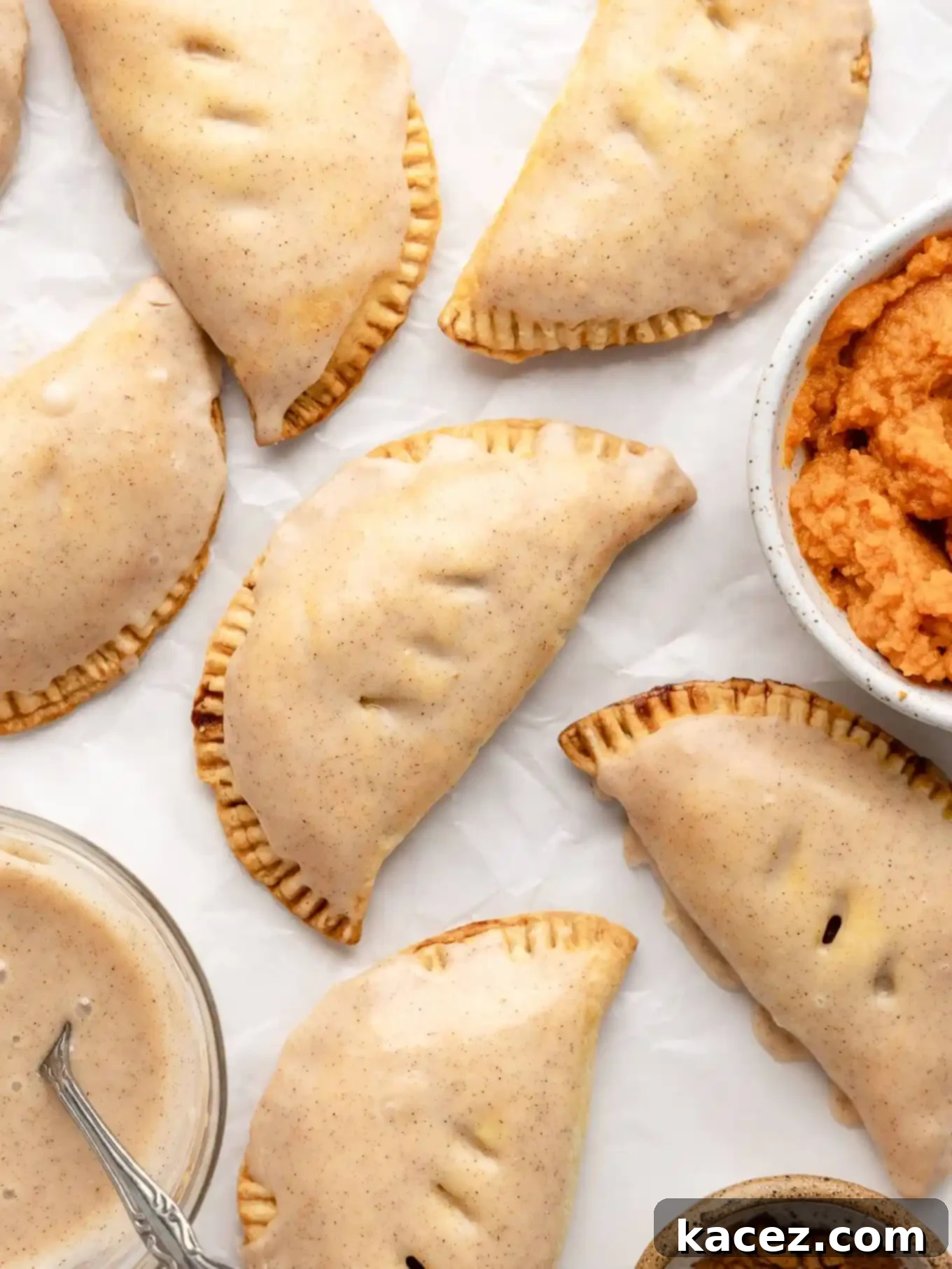Spiced Pumpkin Pastries 10 An overhead view of several glazed pumpkin hand pies, glistening and ready to eat.