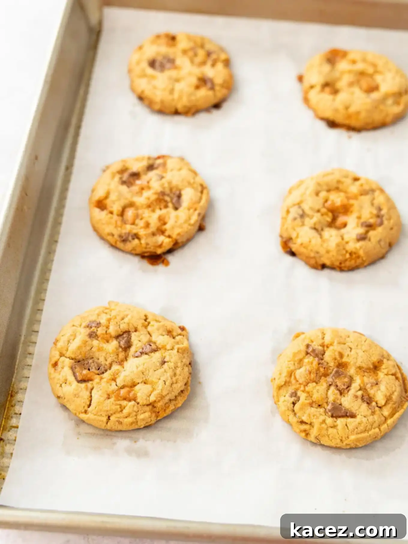 Sweet & Crunchy Butterfinger Treats 6 Butterfinger cookies, freshly scooped and lightly flattened, arranged neatly on a parchment-lined baking sheet, ready to go into the oven.