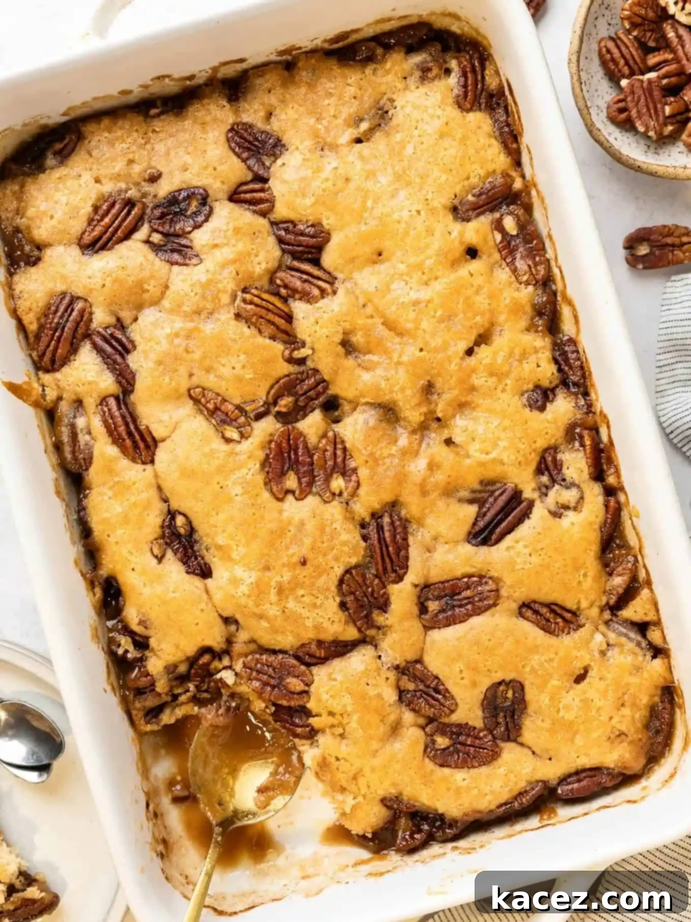 Pecan Cobbler Delight 2 An overhead view of pecan pie cobbler in a baking dish, showcasing its golden-brown topping and rich pecan filling.