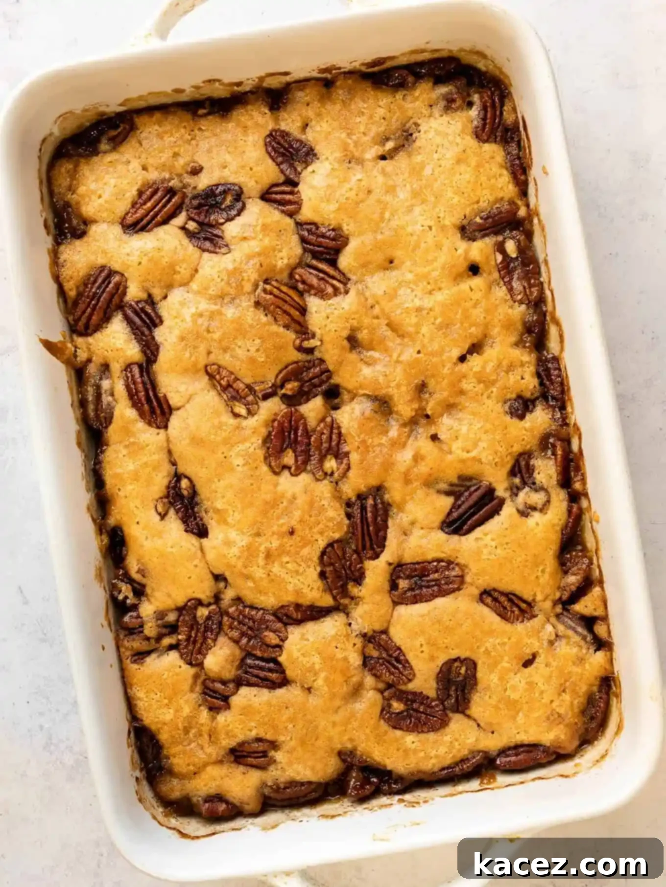 Pecan Cobbler Delight 7 An overhead view of the finished pecan pie cobbler in a baking dish, showcasing its golden-brown crust and bubbling, delicious filling.