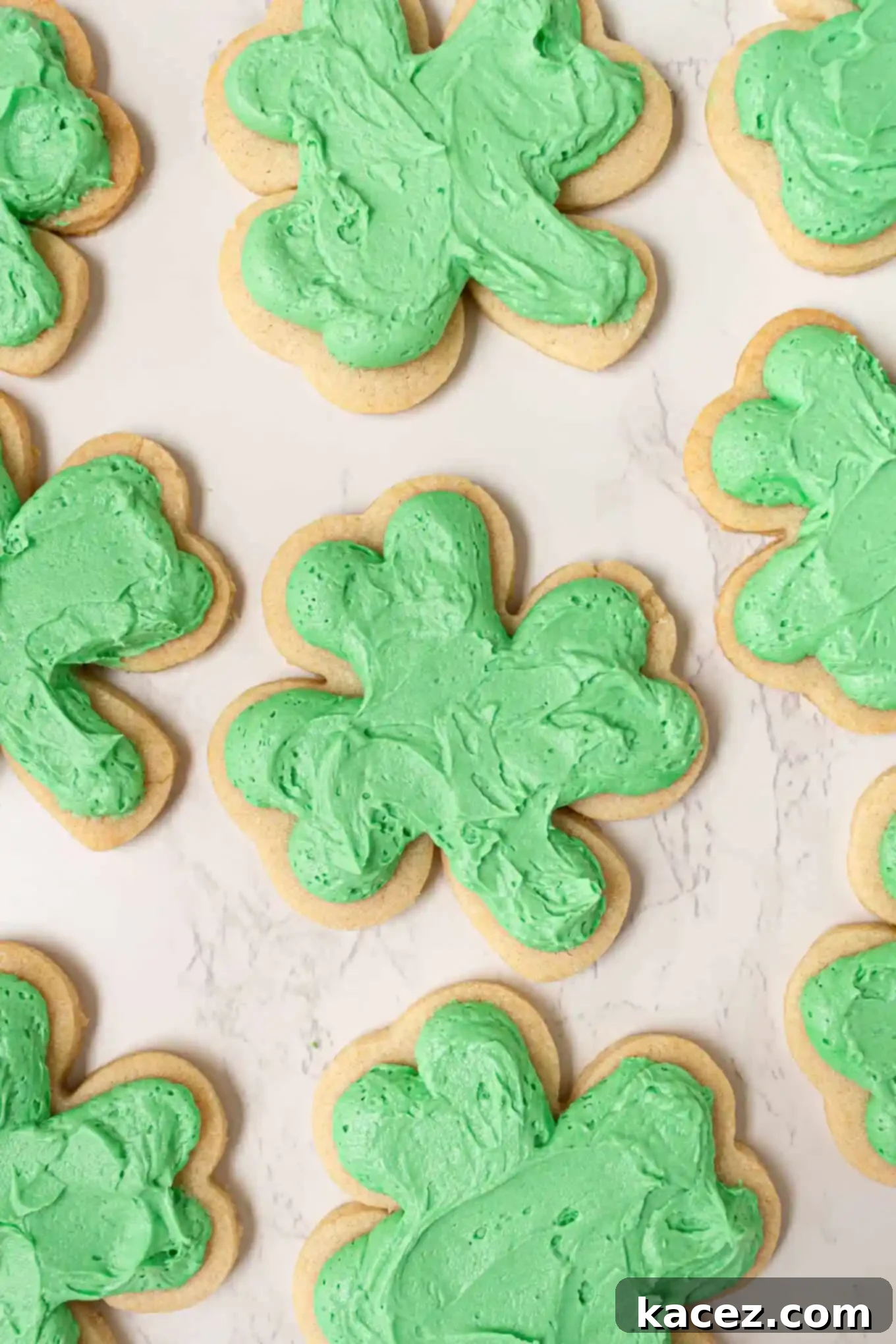 Overhead perspective of perfectly green frosted shamrock sugar cookies, ready for a St. Patrick's Day feast.