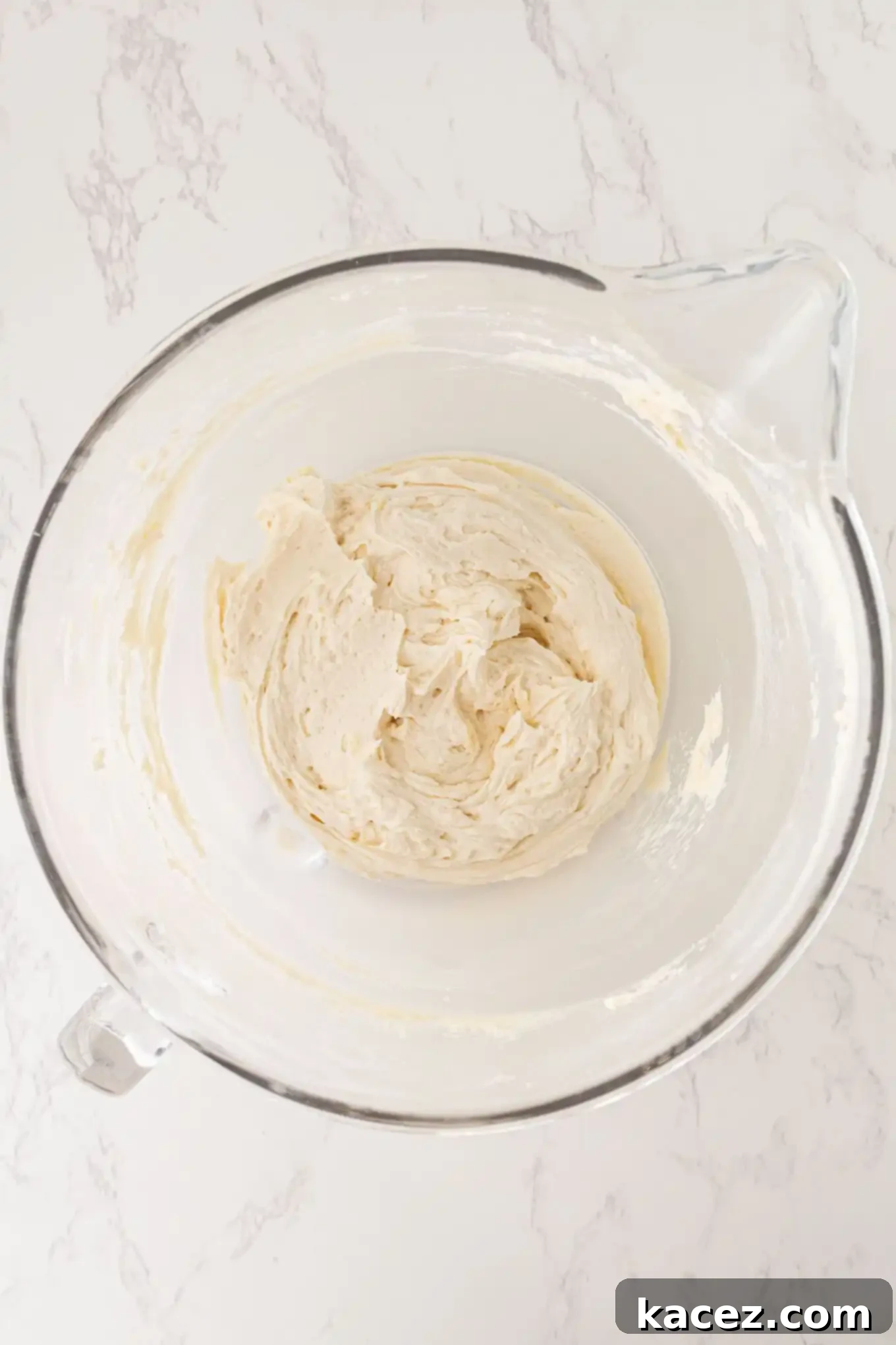 Guinness Chocolate Dream Cake 5 An overhead view of Baileys frosting being mixed in a bowl.